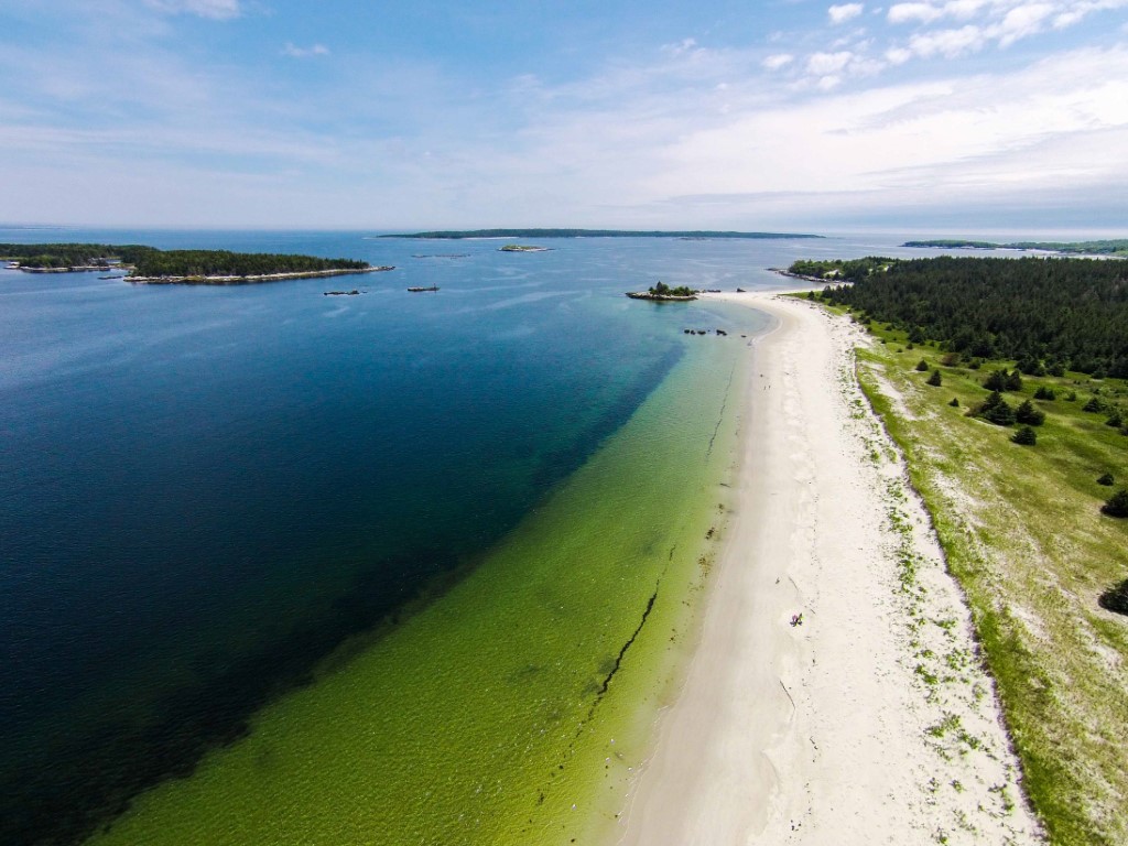 Aerial view of Carter’s Beach, one of the best beaches in Nova Scotia, with white sand and turquoise water