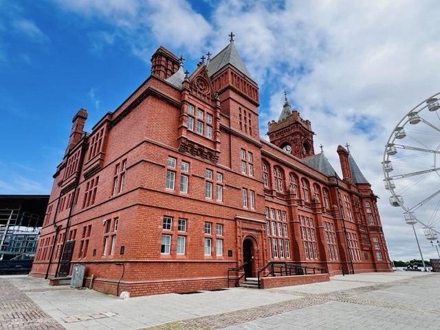 Wide view of the Pierhead Building beside the Cardiff Bay Ferris wheel